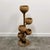 A beautiful vintage multi-tier bamboo plant stand featuring four sculptural woven bamboo bowls, arranged at different...