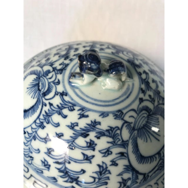 Tongzhi Era, circa 1870 having foliate decoration covered porcelain ginger jar. Iron handles on the sides and a foo dog...