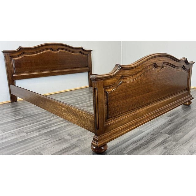 This Vintage French king size bed frame features beautifully shaped panelling, elegant moulded contours and a rich oak...
