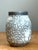 This vintage ceramic vase showcases the enduring beauty of traditional crackle glaze techniques, blending understated form...