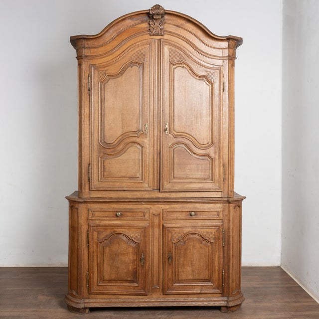 Late 18th-century tall French oak cabinet or "Deux corps" with brass hardware and traditional carved panel doors and...