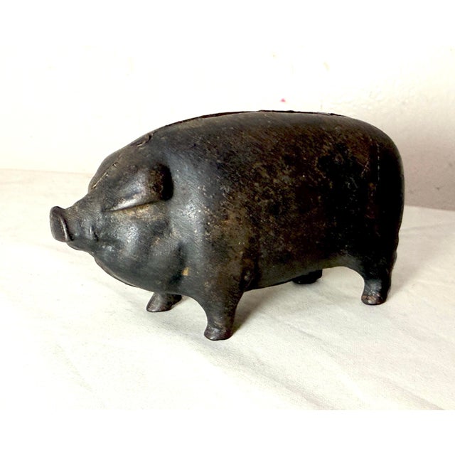 The rare antique 1920's figural cast iron piggy bank is a unique and highly sought-after collectible item. This original...