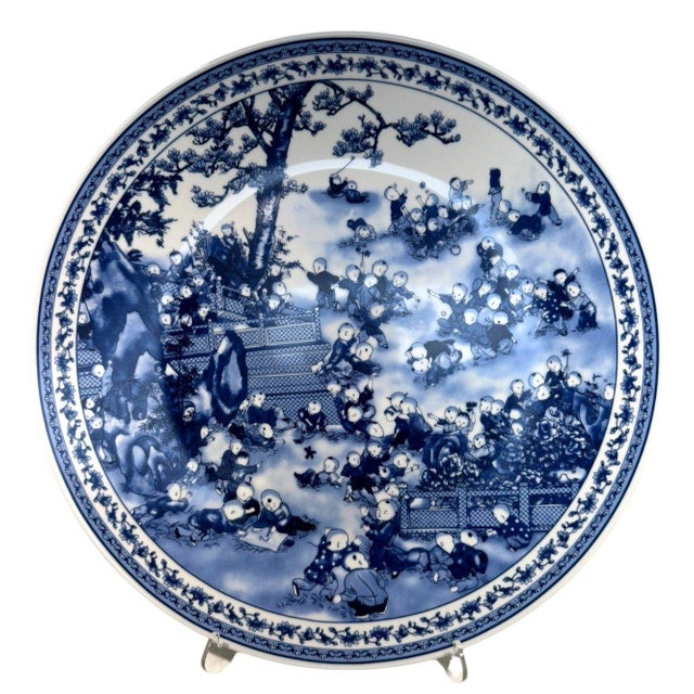 Beautiful large Chinese-style blue and white porcelain charger featuring the traditional Hundred Boys (Bai Zi Tu) motif,...