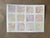 A soft and whimsical abstract drawing featuring twelve delicate pastel-toned squares filled with intuitive looping lines...