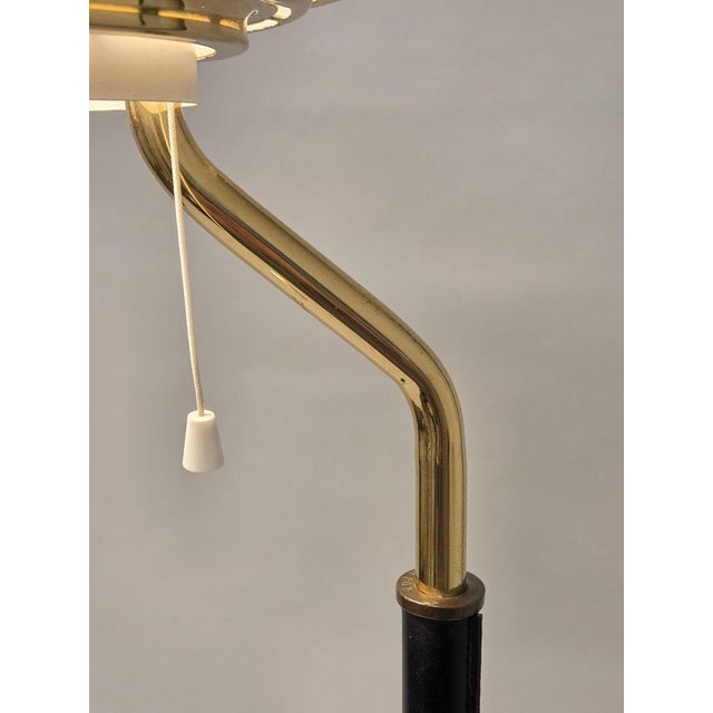 Artek A808 lamp, brass shade with white bottom grille, and brass base with black leather. Manufacturer Valaistustyö,...