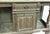 vintage green distressed console table features turned legs, a central drawer over a single door , and lower storage...