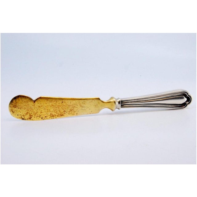 Butter Knife in Gilded Silver with Grooves Along the Handle, in Very Good conditions. Designed 1920 to 1949 This piece has...