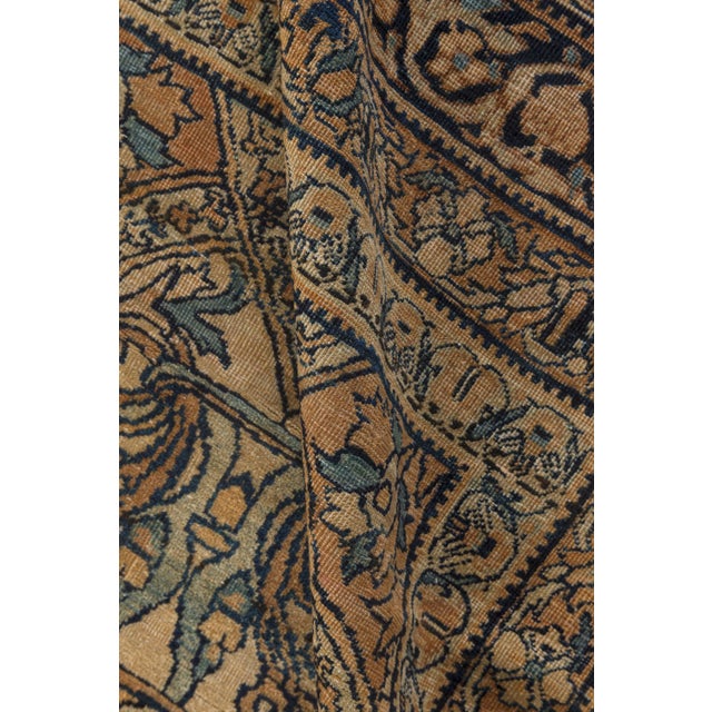 A late 19th century antique Persian Kirman (Kerman) rug, with an allover design of alternating cocoa and cream stepped...