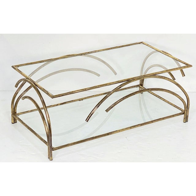 A fine French Modern rectangular low or coffee or cocktail table, featuring a two-tiered patinated brass frame with an...
