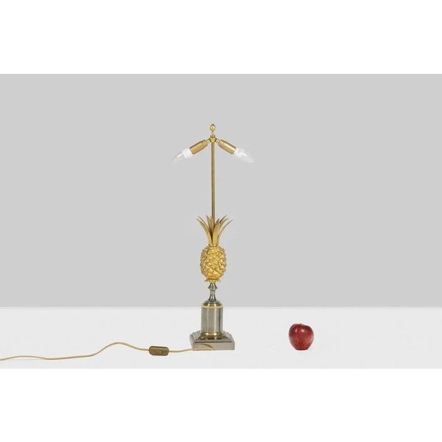 Maison Charles. Gilt bronze lamp representing a stylized pineapple. Polished silver-colored base. French work realized in...