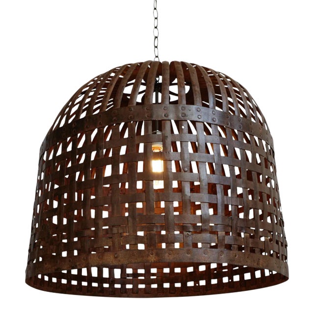 Vintage Indian iron cage basket thoughtfully repurposed into a one-of-a-kind pendant light, celebrating the raw beauty of...