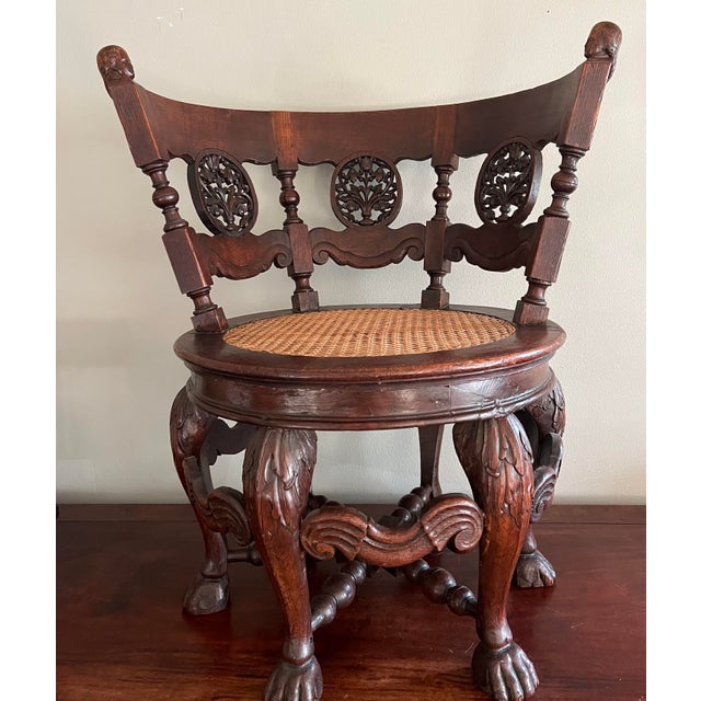 Pair of 19th Century Teakwood Burgomaster Chairs with Caned Swivel Seats A striking pair of 19th-century teakwood Dutch...