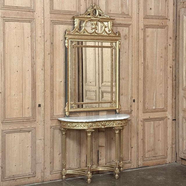 19th Century French Louis XVI Giltwood Carrara Marble Top Demilune Console is a masterpiece in classical architecture and...