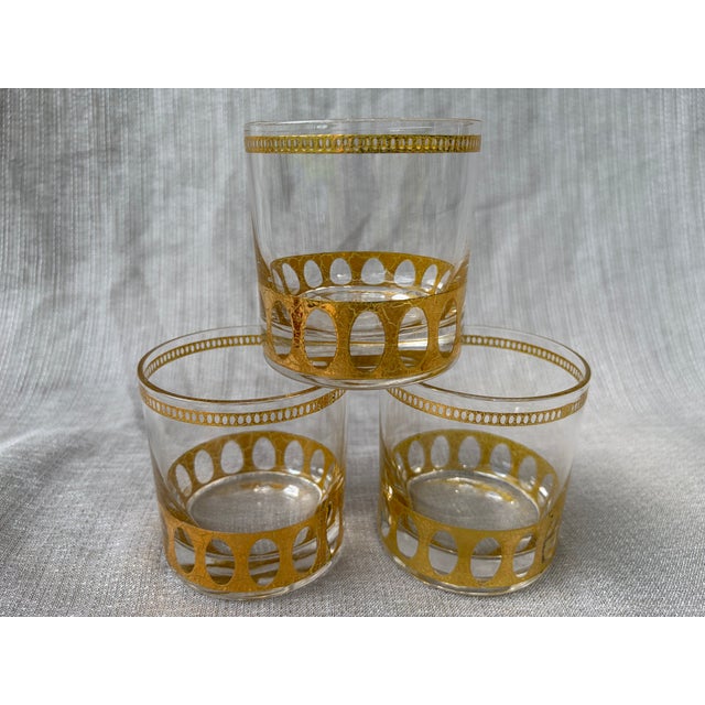 MCM vintage set of three clear lowball glasses with a modern open 22k gold design along the rim and base. Very good...