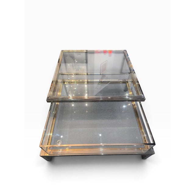 Large square coffee table with an architectural design, typical of modernist furniture from the 1970s and 80s. The...