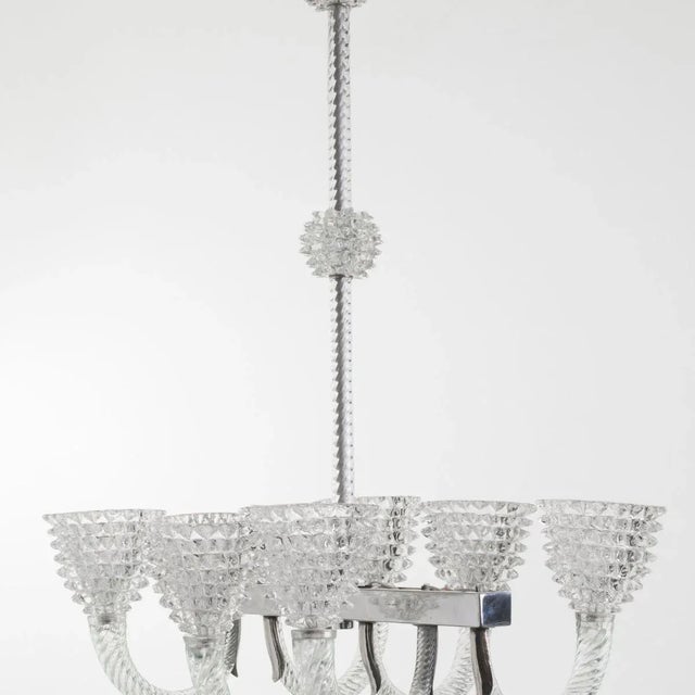 Vintage handblown clear glass [rostrato] oblong-shaped chandelier comprised of six lights. Ornate silver fittings and...