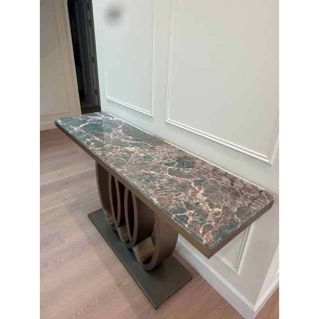 Elegant console table with a thick natural Amazonite quartzite top showing distinctive blue-green veining. Stainless steel...