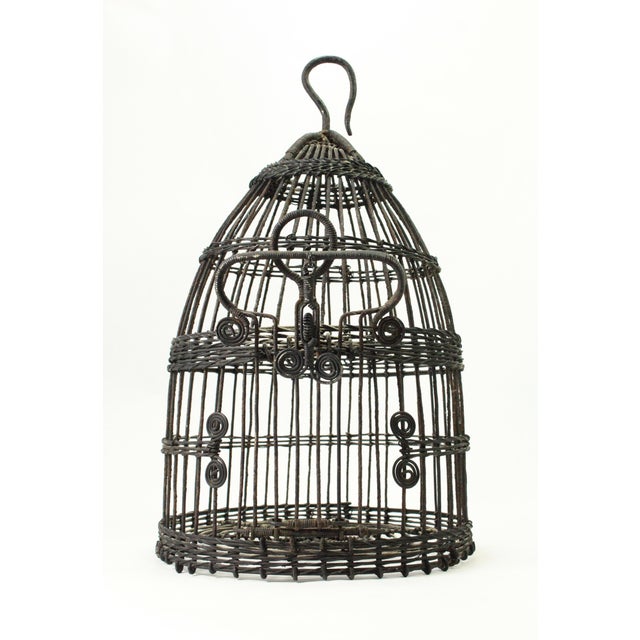 A very beautiful antique bird cage Made of twisted wire, shaped as a beehive with a small door Sturdy hook for hanging...