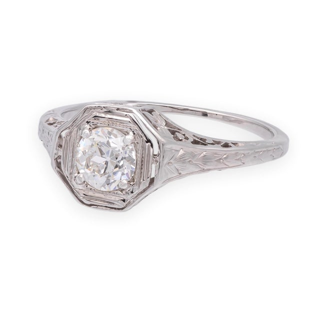 A beautifully preserved Art Deco solitaire, entirely hand-fabricated in 14k white gold with an octagonal filigree setting...