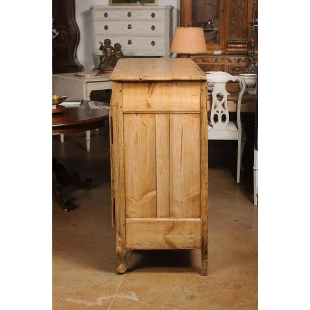 A French Louis XV style wooden buffet from the late 19th century, with molded doors, carved apron and cabriole legs....