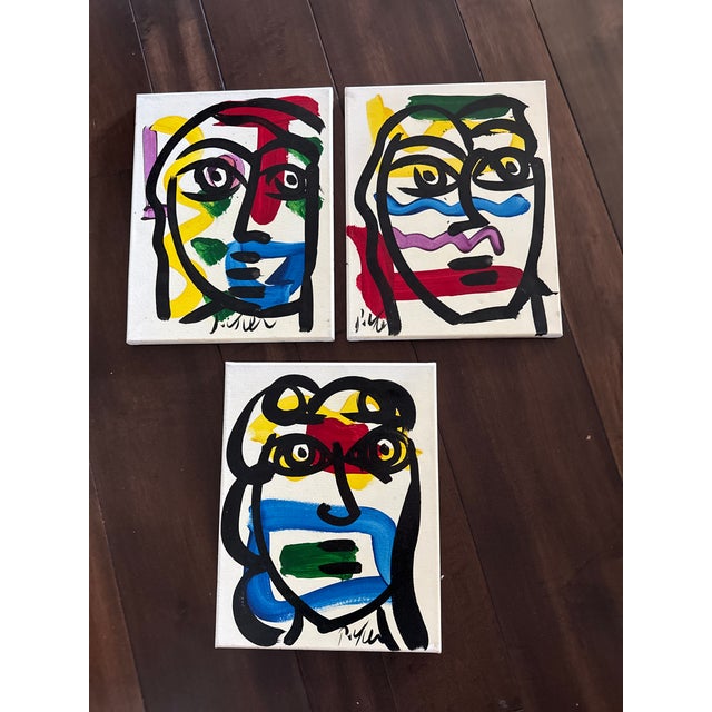 Terrible set of 3 matching canvas paintings by Peter Robert Keil. Each depict colorful abstract faces on a great size 14”...