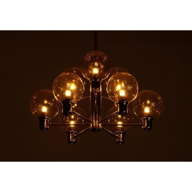 Brass & glass chandeliers by EWÅ, Sweden, 1960s. This piece is attributed to the mentioned designer/maker. It has no...