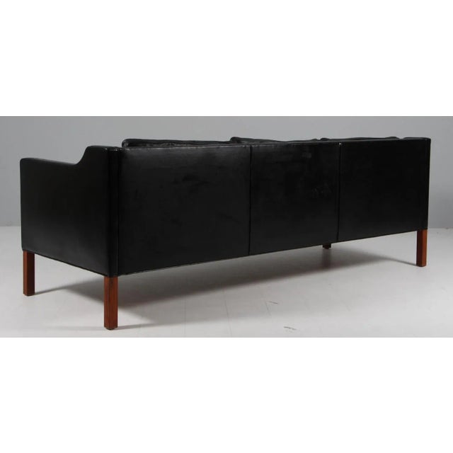 Børge Mogensen three-seat sofa with original patinated black leather upholstery. Legs of teak. Model 2213, made by...