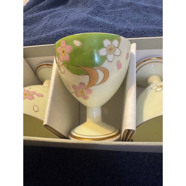 Beautiful set of 5 vintage Japanese stemmed glasses featuring delicate pink cherry blossoms on a creamy ivory background...