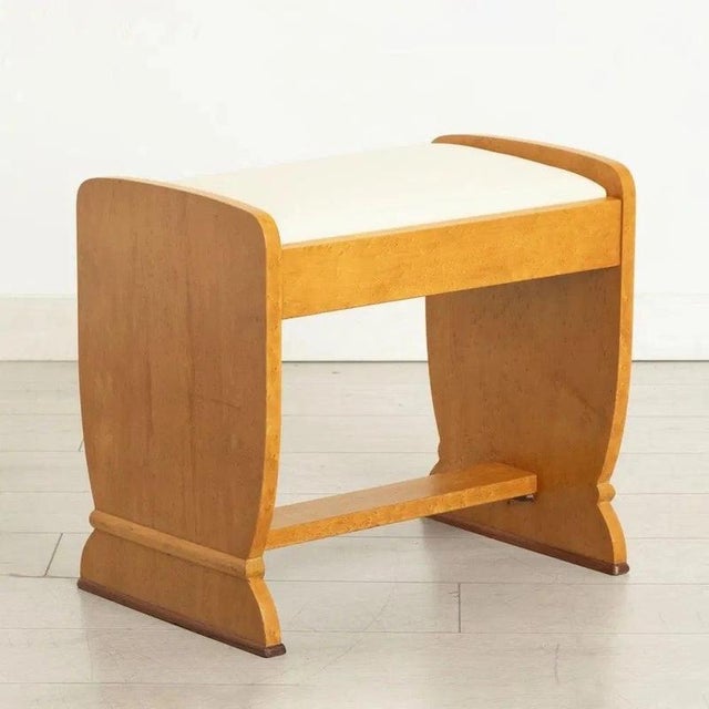A beautifully proportioned British Art Deco dressing stool, dating to circa 1930 and crafted in richly figured golden...