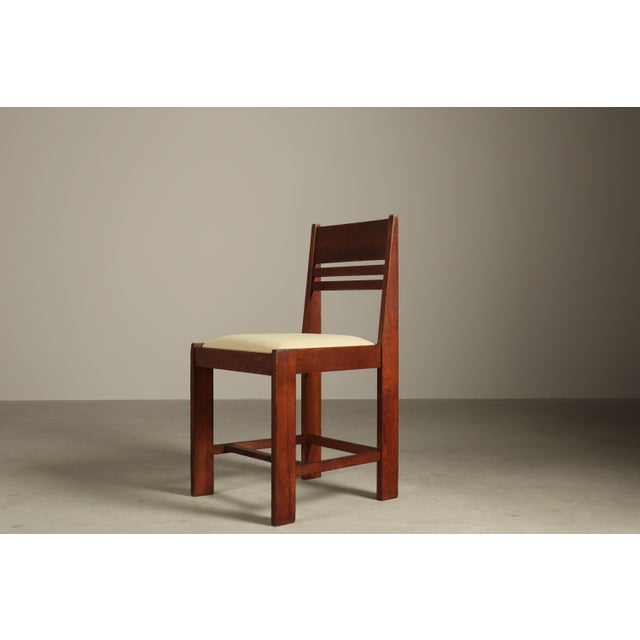 This set of four dining chairs originates from the Netherlands and dates to the interbellum period, circa 1925–1935. The...