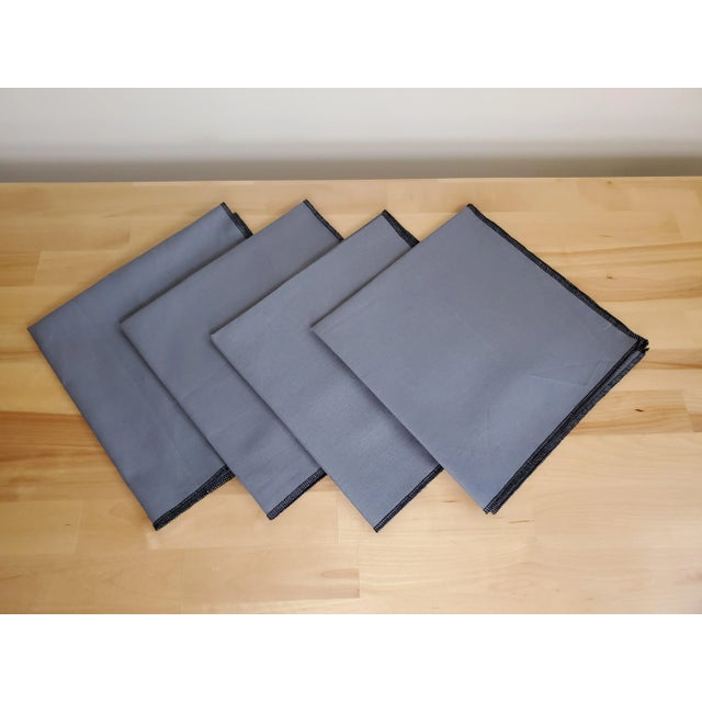 This is a set of four newly made napkins in 100% linen with an overlock stitch around the edge for a modern twist and a...