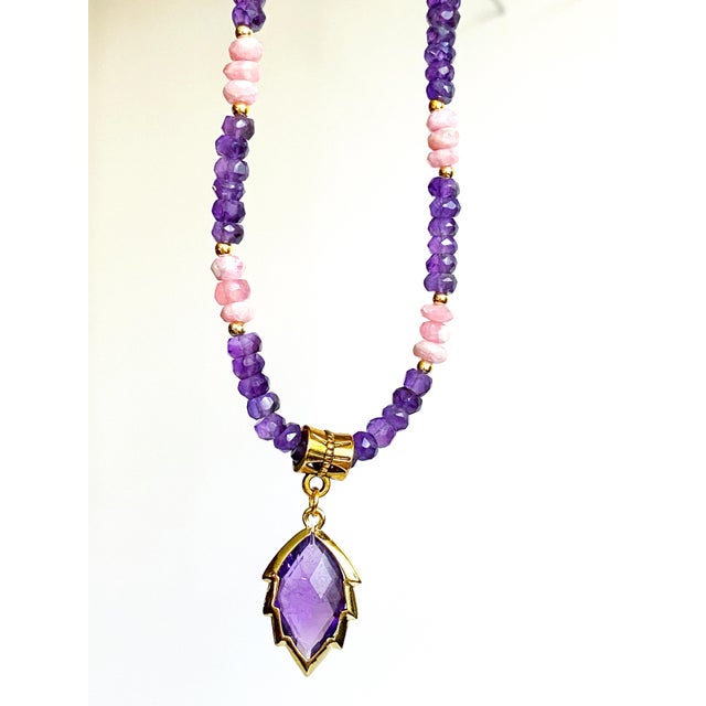 Rich in color and artistry, this one-of-a-kind handcrafted necklace pairs vibrant faceted Amethyst with rare genuine...
