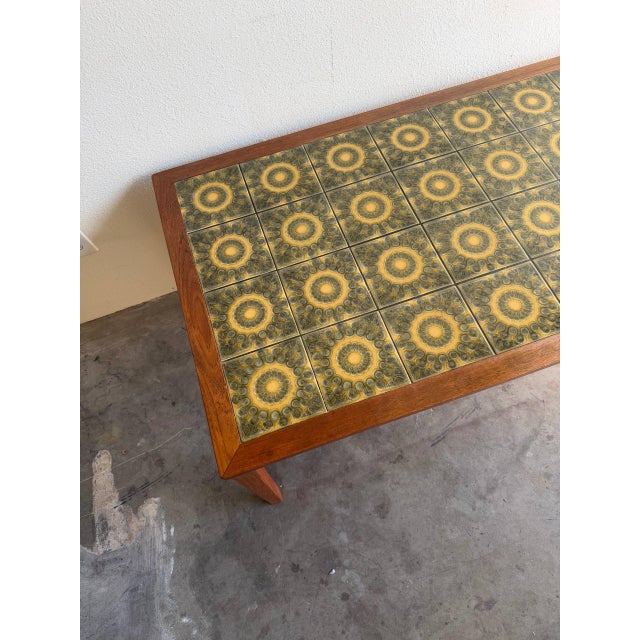 Danish Modern coffee table crafted in warm solid teak with an eye-catching tiled inset top featuring a geometric mid-...
