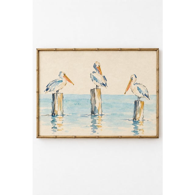 Three pelicans perch on weathered harbor posts above pale turquoise water in this charming coastal art print. Delicate...