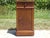 A Louis-Philippe style bedside table (mid-19th century), with clean lines, featuring a cyma recta (the rounded molding...
