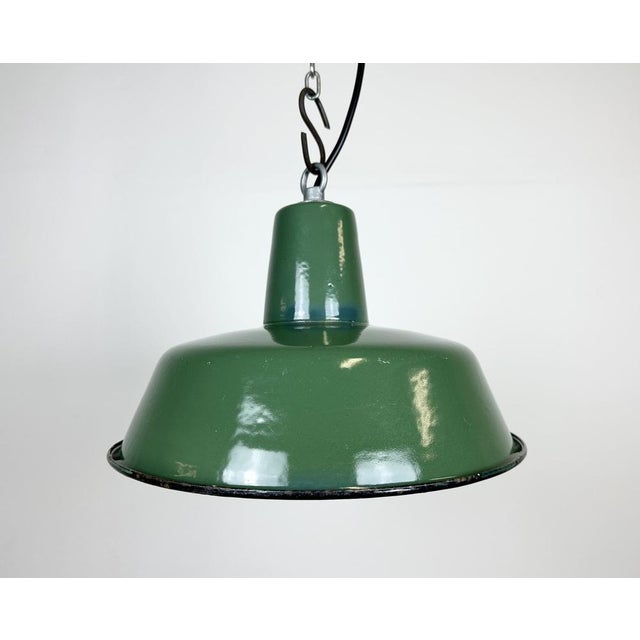 Industrial green enamel pendant light made in Poland during the 1960s. White enamel inside the shade. Iron top. The...