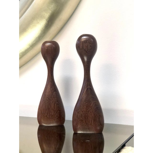 A pair of sculptural candleholders. Done in an organic style, seemingly identical, with subtle but noticeable differences...