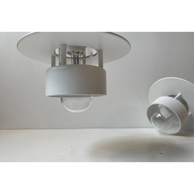 A set of small white pendant lights suitable for outdoors or bathroom . They are called 'planet of albertslund' or...