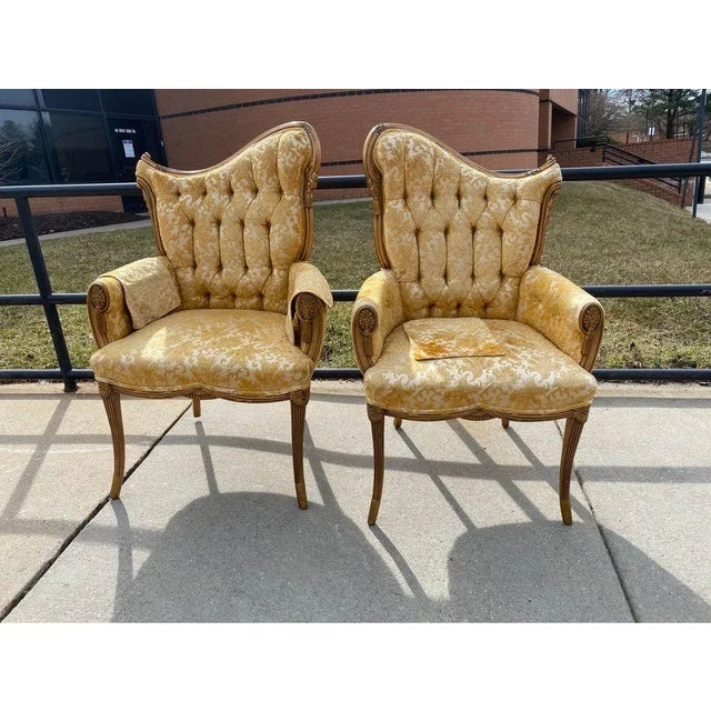 Pair of Hollywood Regency Style Gilt Painted and Tufted Back Upholstered Chairs; Pair of 1940s saber leg fireside lounge...