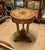 Bring timeless European elegance into your home with this exquisite French Empire style round accent table. Featuring a...