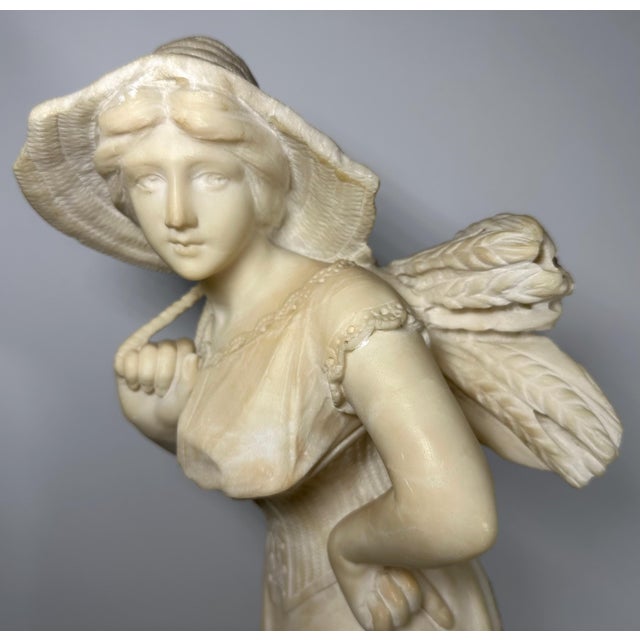 Antique Alabaster Carving of Lady Carrying Bundle of Wheat by Adolfo Luchini for your consideration. The statue is a nice...