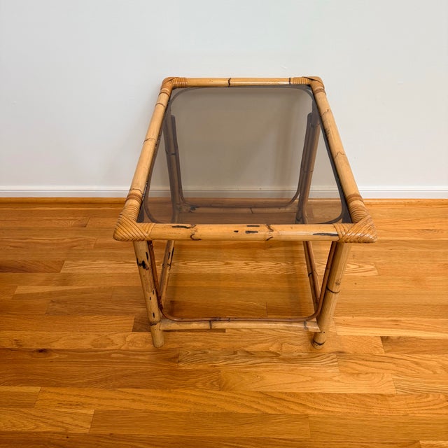 A beautifully relaxed pair of vintage burnt bamboo and rattan side tables with smoked glass inset tops and the kind of...