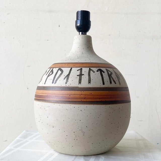 Amazing vintage Danish pottery table lamp by Hans Nielse Buch. Features a fantastic painted design inscribing the bust of...