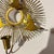 Sexton style metal wall sconce in the manner of Curtis Jere. Some wings show a small crease where the wing might have...