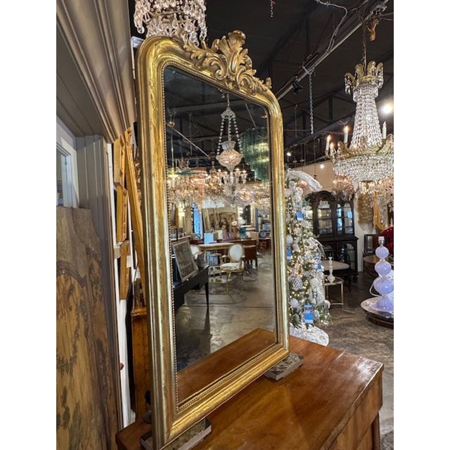 The 19th Century Louis Philippe Gold Gilt Mirror with Crest is a luxurious and elegant addition to any home décor. The...