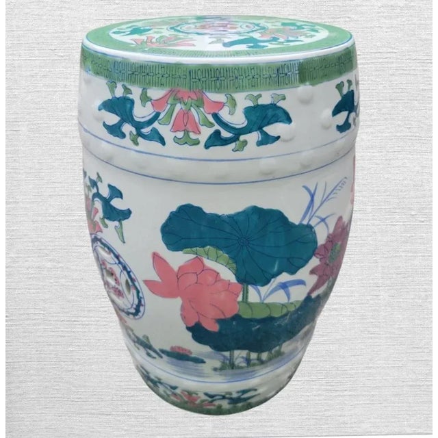 A pretty vintage floral Chinoiserie garden stool. The stool features colorful flowers with a green rimmed chinoiserie...