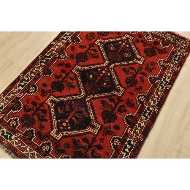 An authentic vintage tribal Shiraz rug hand-knotted with fine wool and natural dyes. This nomadic rug features geometric...