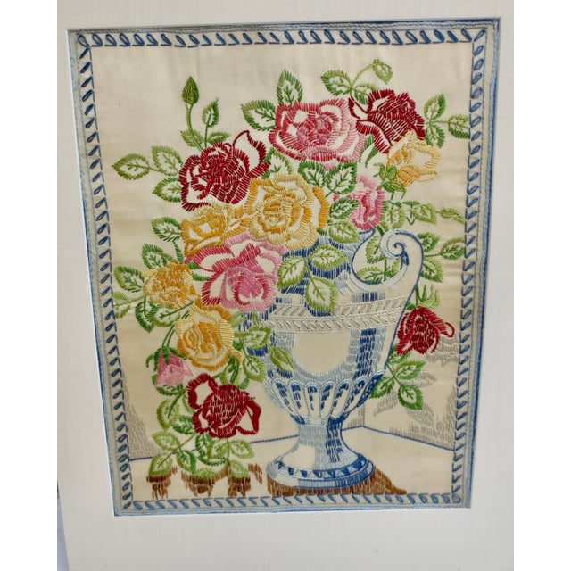 A beautiful Floral sampler of a rose bouquet in a classic urn. Shades of blue, green, and red shiny threads. Clean and...
