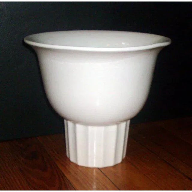 A highly stylized Art Deco flower vase with an integral frog at the base. Bell shaped like a search light in a machine age...