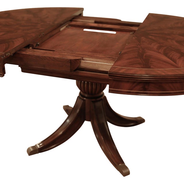 2020s Round Mahogany Pedestal Table, Opens to 66" Oval With a Self-Storing Leaf, Duncan Pfyfe-Inspired Saber Leg Pedestal For Sale - Image 5 of 12